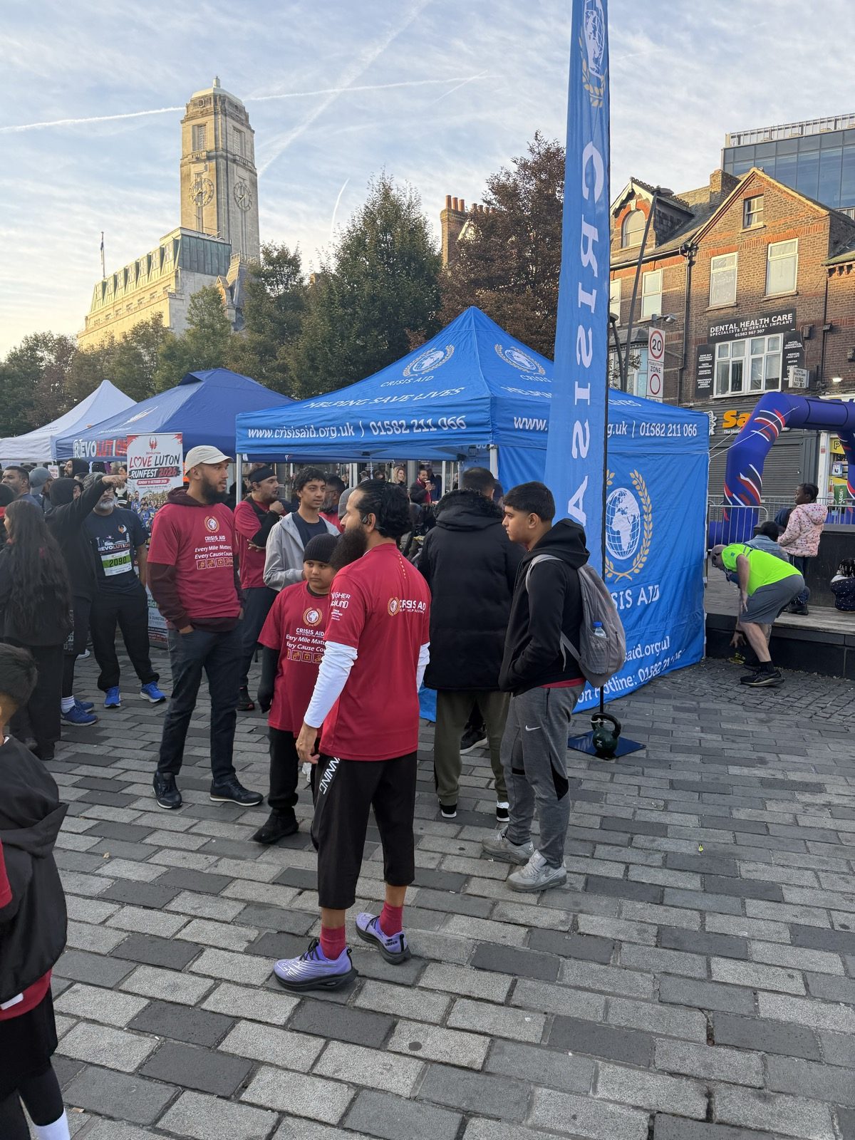 Runners in Crisis Aid shirts at the Crisis Aid stand beside Luton Town Hall
